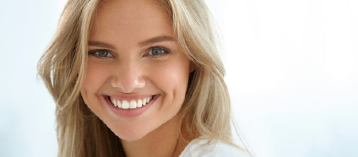 61732890 - beauty woman portrait. closeup of beautiful happy girl with perfect smile, white teeth smiling at camera. attractive healthy young female with fresh natural face makeup indoors. high resolution image
